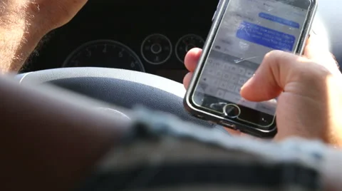 Driving and texting Stock Footage 52681512