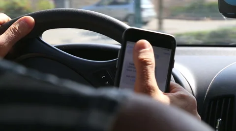 Driving and using mobile phone Stock Footage 52681906
