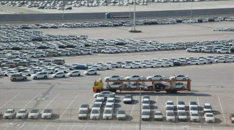 Driving automobile transporter with new cars in parking in Abu Dhabi, UAE Stock Footage