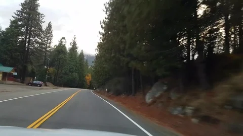 Driving in autumn color forest between mountains, on route 89, near lake ta.. Stock Footage 72416745