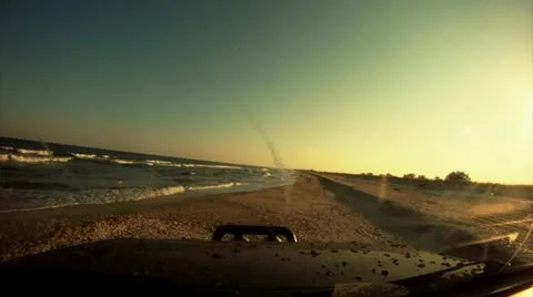 Driving on the beach at sunset Video stock 14808347