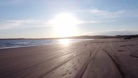 Driving on the beach at sunset Stock Footage 155313606