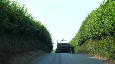 Driving behind big farm tractor on narrow country road Vídeos de archivo 139899765