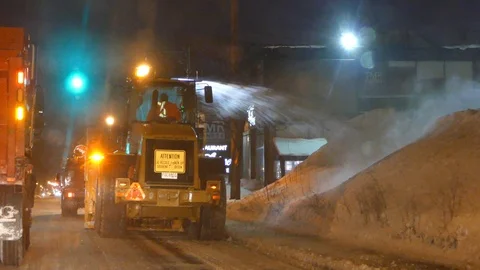 Driving behind snowblower that is in function and shooting snow on large pile 스톡 동영상 101221226