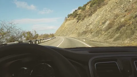 Driving behind a wheel on a mountain asphalt road Stock Footage 82932423