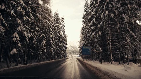Driving between snow-covered trees after snowfall in Alps, Austria at winter day Stock Footage 102292343