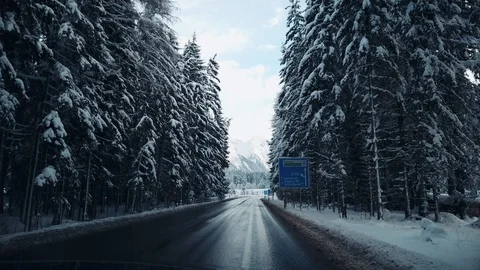 Driving between snow-covered trees after snowfall in Alps, Austria at winter day Stock Footage 102292637