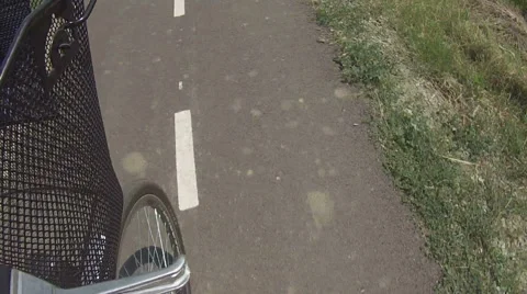 Driving bicyle - front wheel and the basket on the bicycle Stock Footage 55018860