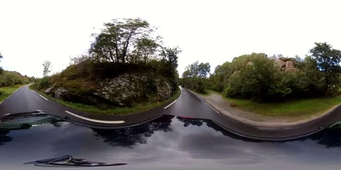 Driving black car - Tiny one lane road between houses Stockbeeldmateriaal 94879988