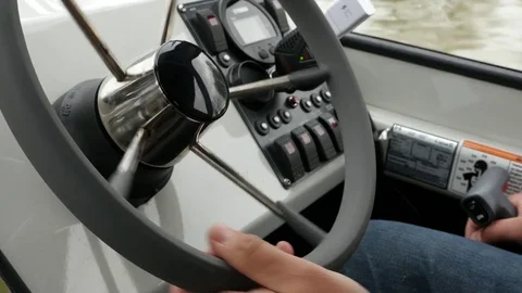 Driving boat on the river. Hands on steering wheel. Close Up. Stock-Footage 74713403