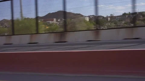 Driving on Bridge El Paso Texas Border Fence Looking at Juarez Mexico Video stock 153447079