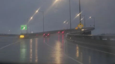 Driving on bridge at night in rain Stock Footage 232799388