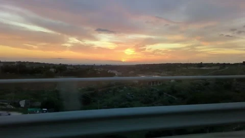 Driving on a Bridge at Sunset with a Colorful Cloudy Sky Video stock 316712908
