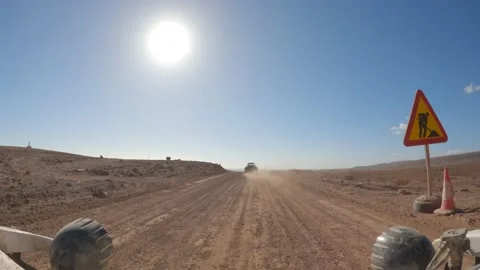 Driving a buggy on a dirt track with small hills, mountains, and vulcanos Video stock 175670177