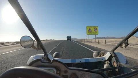 Driving a buggy on a paved road during a perfect sunny day Video stock 175682448