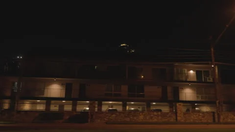 Driving by buildings at night, camera pointing out car window Stock-Footage 299621488
