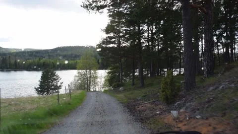 Driving on bumpy narrow gravel track towards a river in spring Video stock 166223425