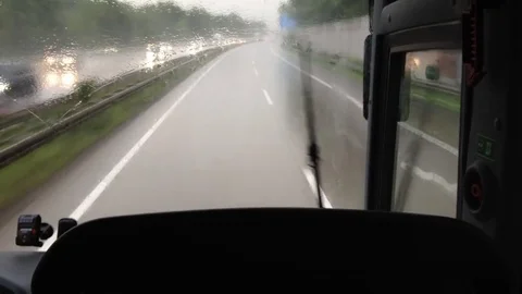 Driving with a bus through the rain on the autobahn Stock Footage 76510488