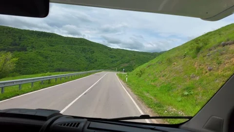 Driving a camper van on a winding mountain road Stock Footage 346883120