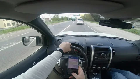 Driving car and texting message on the phone Video stock 166844132