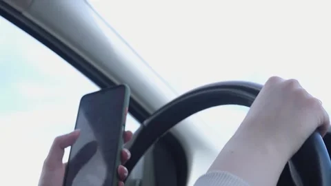 Driving car and using phone. Distracted driver texting with mobile cellphone. Video stock 275189320