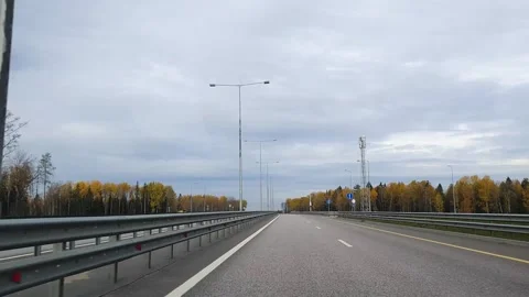 Driving a car on asphalt empty road highway with color trees in autumn Stock Footage 201773077