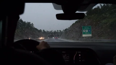Driving A Car On A Bad Weather With Lightning In Background - Medium Shot Stock Footage