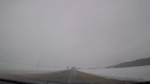 Driving a car in bad winter weather Stock Footage