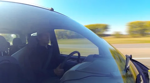 Driving a car, camera aimed at the driver through the windshield. Timelapse. Stock Footage 44888754