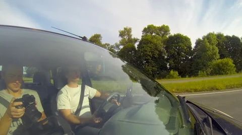 Driving a car, camera aimed at the driver through the windshield. Stock Footage 54898388