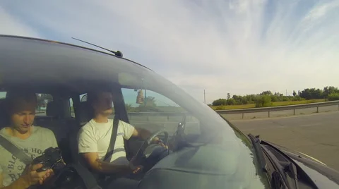 Driving a car, camera aimed at the driver through the windshield. Stock Footage 54899214
