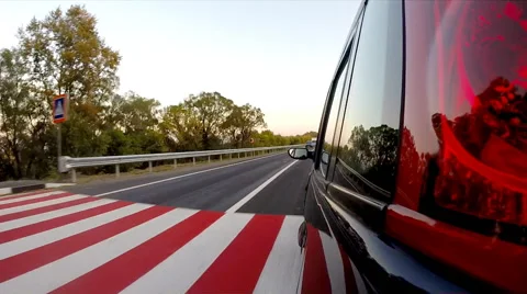 Driving a car. The camera is left outside. Sunset time Stock Footage 42622638