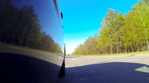 Driving a car. The camera is outside and aimed back. Stock Footage 49797954