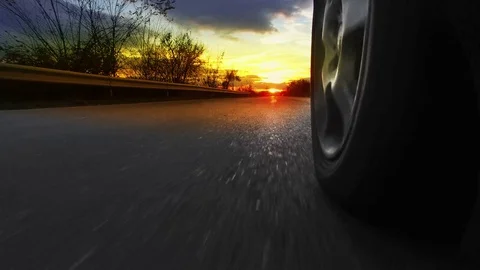 Driving a car on a country road at sunset, sunrise. Fast Speed Race Stock Footage 69986596