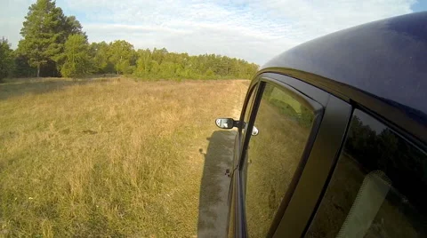 Driving a car in the countryside. The camera is located outside left. Stock Footage 42773796