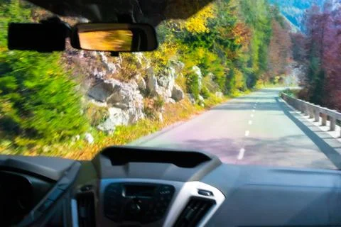 Driving car down the mountains with a caption view of the road taken through the Foto stock