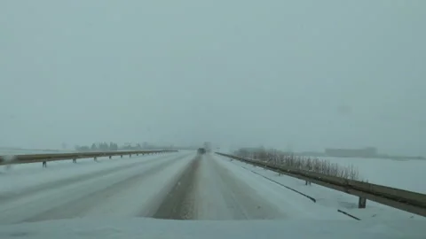 Driving car down the road during severe snow storm blizzard Video stock 169652539
