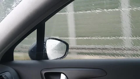 Driving a car during heavy rain. Severe weather conditions while traveling. Video stock 246912835