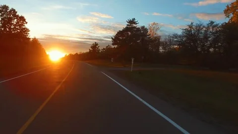 Driving a Car on an empty and curvy Road into Sunset. Stock-Footage 84869340