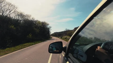 Driving a car on an empty asphalt road through the countryside, POV shot 库存影片 333560414