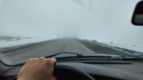 Driving car on an empty road with heavy fog in winter Видео 334153643