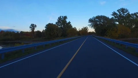 Driving a Car on an empty Road at Sunset - 3 of 7.. Video stock 84869417