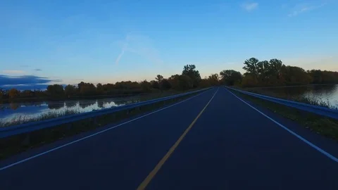 Driving a Car on an empty Road at Sunset - Time Lapse Stock Footage 84869519