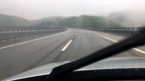 Driving with car on highway during rain, crossing bridge, driver's view Stock Footage 109393045