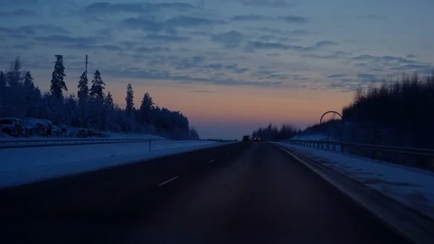 Driving car on highway in evening time snowy winter lanscape Stock Footage 100572455