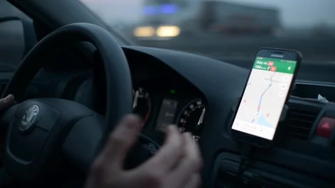 Driving a Car on a Highway at the Night using a Mobile Navigation app Maps Stock Footage 99994270