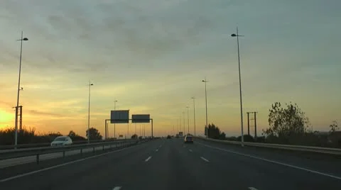 Driving car in highway at sunset Stock Footage 8946199