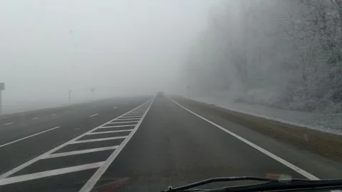 Driving Car on Highway Through Heavy Fog in Winter Stock Footage 346414525