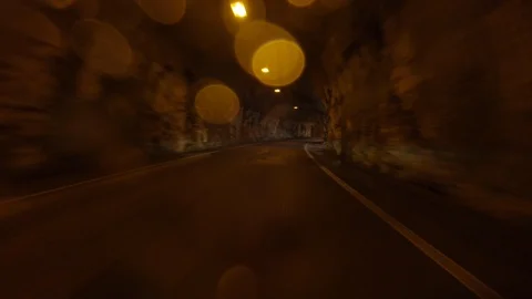 Driving a Car inside an Old Wet Rock Tunnel in Vajont Dolomites Mountain Stock Footage 112193090