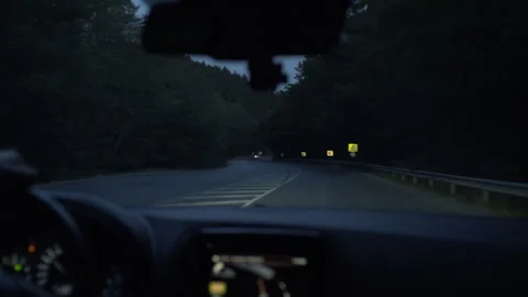 Driving a car on a mountain road at dusk Stock Footage 330195623